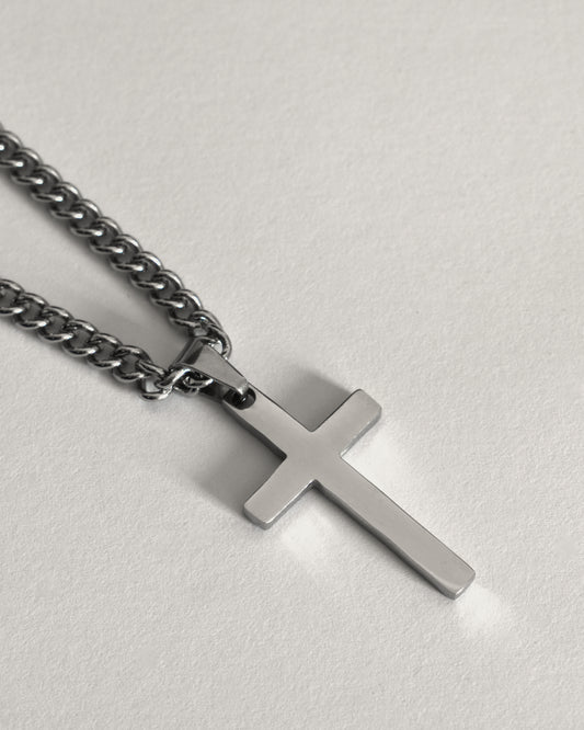 Stainless steel cross necklace on a curb chain